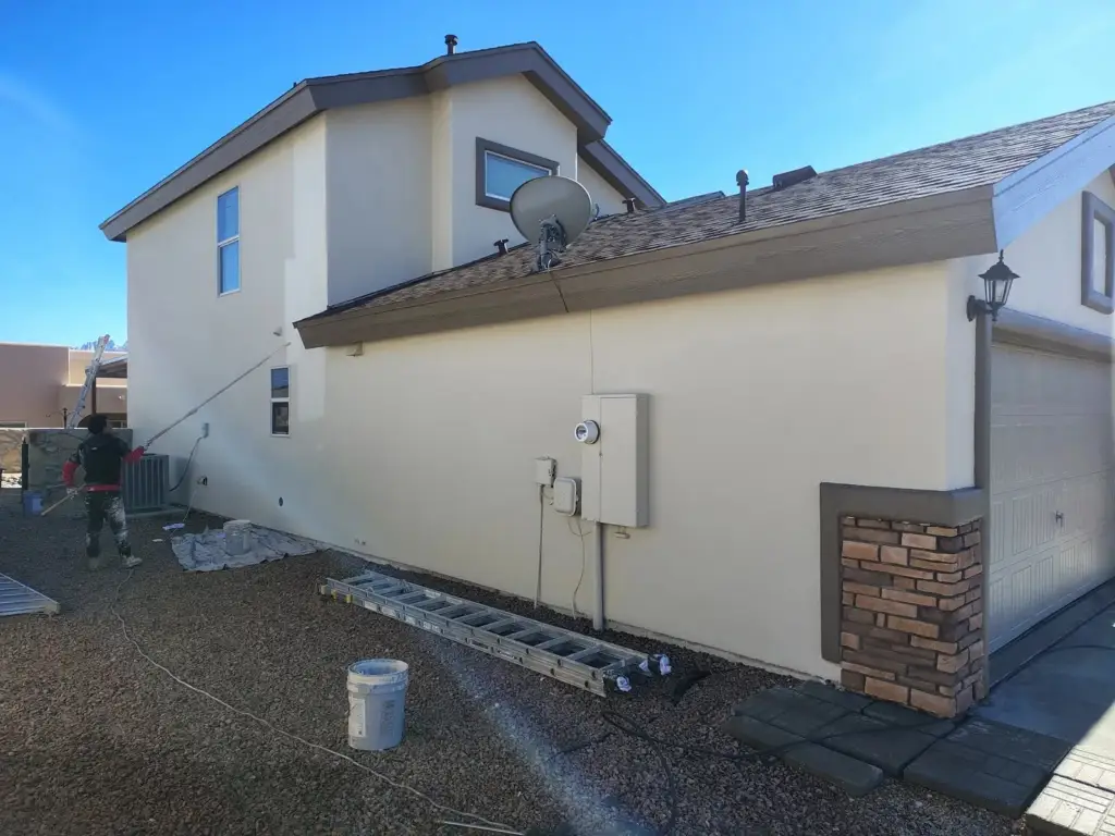 Side of a stucco house with a fresh light elastomeric coating