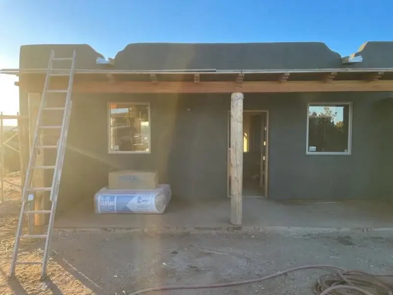 Covered porch with walls in stucco brown coat