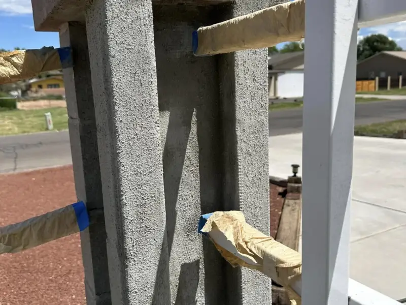 Concrete block pillar in stucco brown coat before the finish